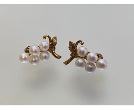 A pair of 9ct gold cultured pearl earrings, each modelled with five uniform pearls as grapes on a vine leaf, clip fittings. L
