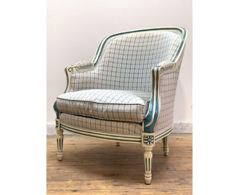 A French bergère in the Louis XV taste, the cream and blue painted fluted show frame enclosing back, squab cushion, and arms 