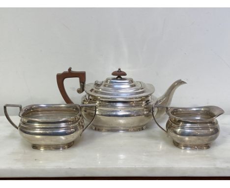 A silver three piece tea service, Sheffield 1961, in the Regency taste, each piece of bellied form. Length of teapot across h