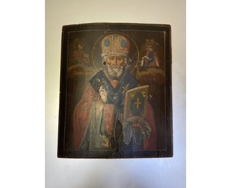 Russian School, an icon depicting a Saint in benediction, holding a bible, crowned within a halo, oil on panel. 31cm by 26cm