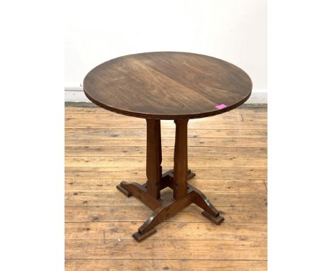 An Arts and Crafts period elm and cherry book table of pegged and jointed construction, circa 1890, the circular top with loz