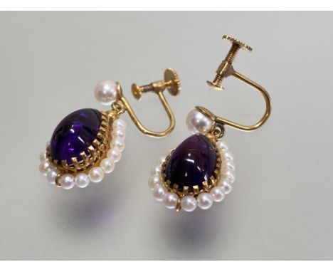 A pair of amethyst and seed pearl drop earrings, each pear-cut amethyst within a band of seed pearls, suspended from a single