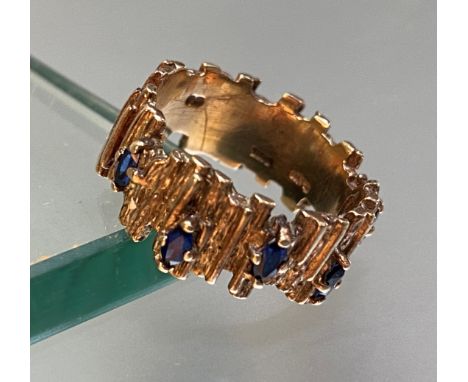 A vintage sapphire-set 9ct gold ring, the textured bark band claw-set with marquise-cut sapphires. Ring size N/O, 6 grams