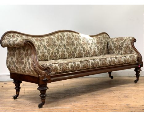 A William IV rosewood framed sofa, the serpentine crest rail over back arms and seat upholstered in a cream ground fabric wor