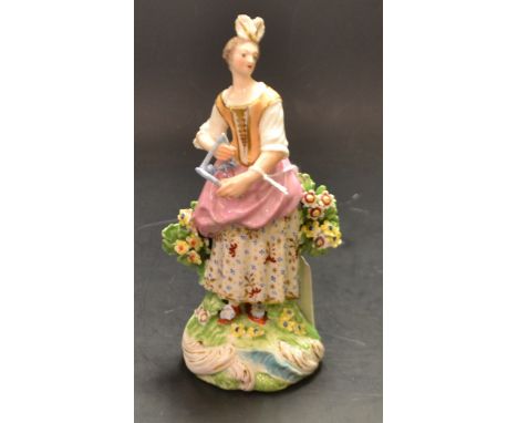 A Derby Patch figure, of a musician, she stands playing the triangle, wearing feathers in her hair, peach and gilt bodice, pi