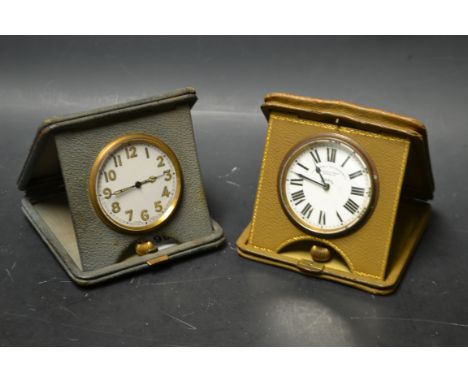 A Goldsmiths and Silversmiths 8 day leather cased travel clock; another leather cased travelling clock (2)
