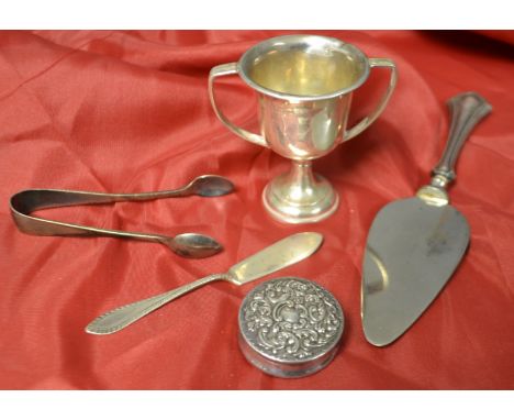 Silverware - a silver circular patch box; a two handled trophy; sugar nips; cake slice and butter knife (5)