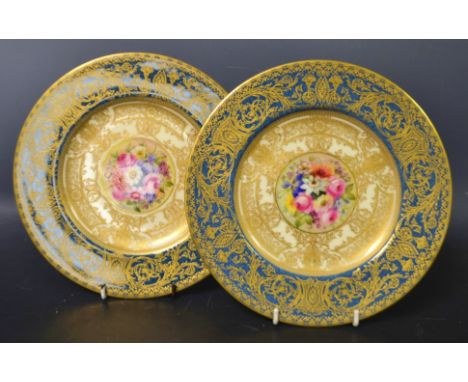 A pair of Royal Worcester circular plates, painted by Ernest Phillips Baker, signed with colourful summer flowers within a cr