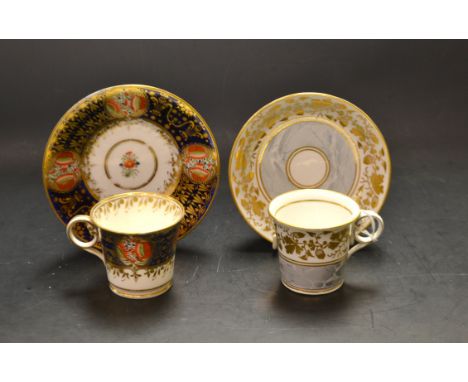 An early 19th century Worcester flared cylindrical cup and saucer, with grey marbled and gilt scrolling acorn and leaf border