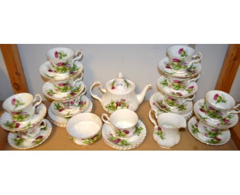 A Royal Albert Highland Thistle tea service comprising, teapot, ten cups, thirteen saucers, eleven tea plates, milk jug and s