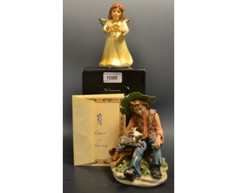A Goebel windup figure of a fairy that play's the twelve days of Christmas;  a Capo de Monti figure of a shepherd with certif