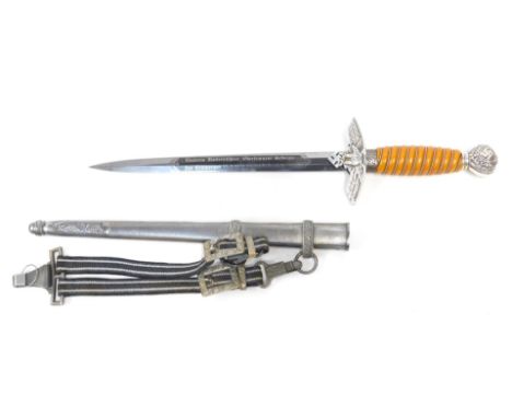 A German Third Reich Luftwaffe dagger, the pommel bearing oak leaves and swastika motifs above an amber ivorine grip interspe