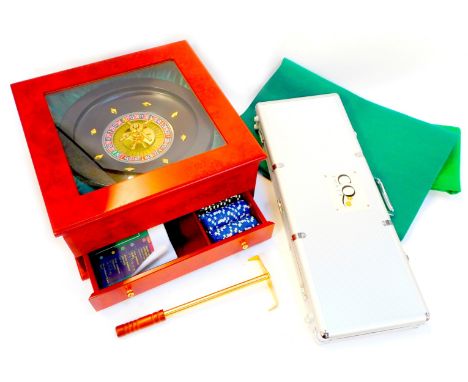A casino games set, comprising roulette wheel, 29cm diameter, contained in a simulated burr wood case, the lower drawer conta