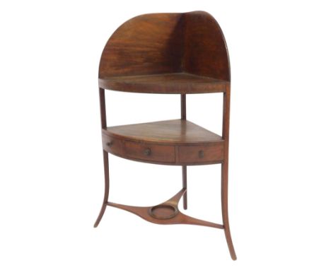 A Georgian mahogany corner washstand, the raised back above a later adapted solid shelf, over a recess with frieze drawer fla