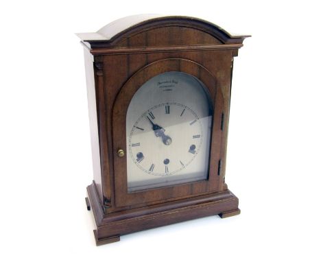 A Thwaites &amp; Reed of Clerkenwell of London walnut cased mantel clock, with a silvered Romanic numeric dial, with Westmins