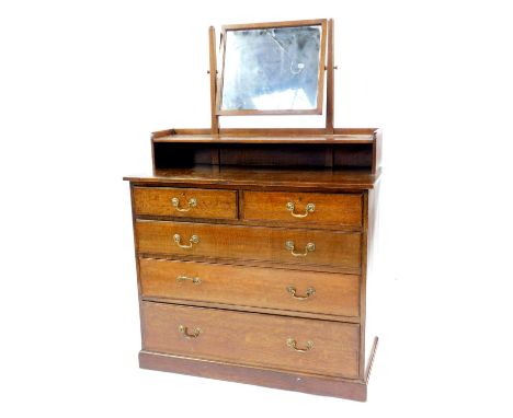 A 20thC oak mirror back dressing chest, stamped Gillows, the rectangular swing frame mirror above a shelf with recess, the ba