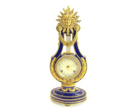 A Victoria and Albert Museum porcelain and brass Marie Antoinette mantel clock, the circular astrological dial bearing Roman 