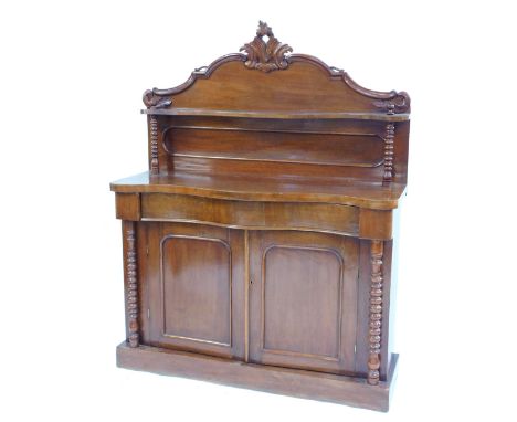 A Victorian mahogany chiffonier, the back with carved decoration, above a shaped shelf raised on bobbin turned supports, base