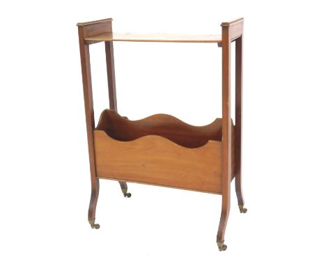 A Victorian mahogany Canterbury, the top with a shelf above a shaped two sectional recess, raised on out swept legs on castor