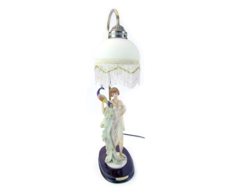 A Juliana Collection table lamp, with frosted glass shade decorated with fringed bead work, above a figure of a lady holding 