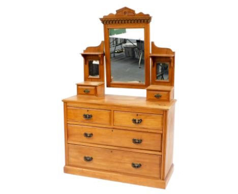 A Victorian satin walnut mirror back dressing chest, the rectangular mirror with carved frieze flanked by a small shelf above