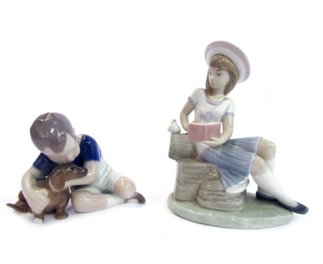 Two Continental figures, comprising a Lladro figure of a girl, seated on hay baskets reading book, 16cm high, and a Bing &amp