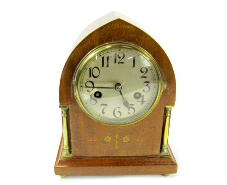 An early 20thC mahogany cased mantel clock, of arched form, the circular silvered dial bearing Arabic numerals, eight day mov