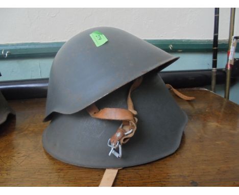 2 East German Army helmets with leather inset head protector and strap.