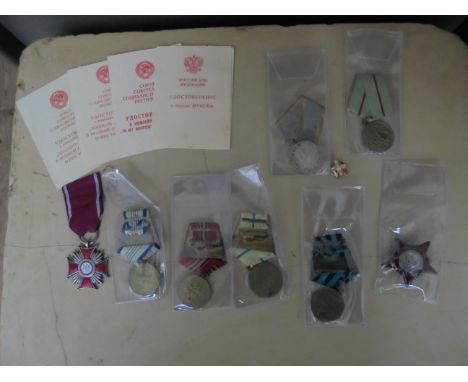 Bag of various Soviet medals to include a 44mm silver and enamel star (in good condition)