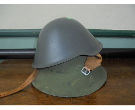 2 East German Army metal helmets, inset leather protector and strap.