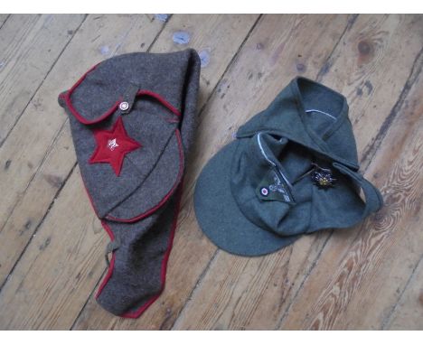 2 Army style cloth caps:- German with ear warming covers and swastika eagle badge and a fabric Russian hat with enameled hamm