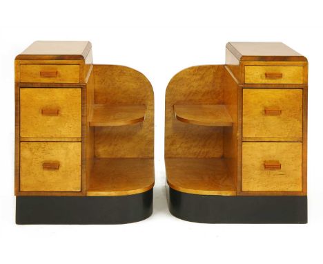 A pair of Art Deco walnut and bird's-eye maple bedside chests, each with three drawers and a shelf to one side, with Bakelite