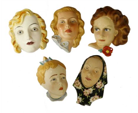 Five Art Deco pottery wall masks, two Goebel, two Czechoslovakian, various marks, largest 18cm high (5)