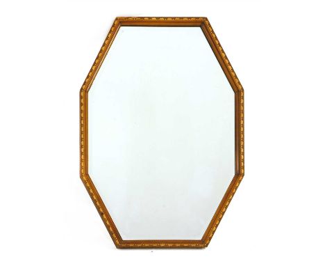 An Art Deco mahogany mirror, with a dogtooth inlaid frame with ivory and ebony details, and a bevelled plate, 88 x 57cm