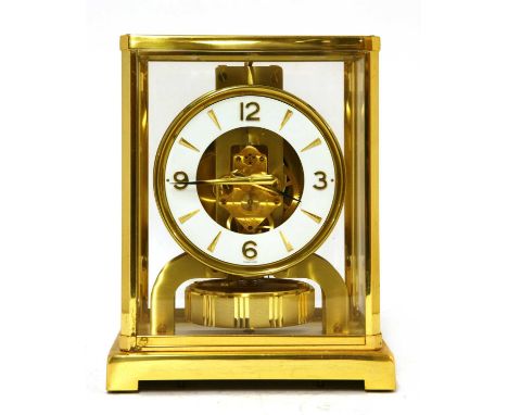 A Jaeger-LeCoultre 'Atmos' clock, with a brass case with five glazed panels and a white circular dial, with dagger and Arabic