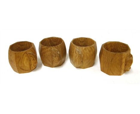 A set of four Robert 'Mouseman' Thompson oak napkin rings, of octagonal form, carved with the signature mouse, 5cm wide