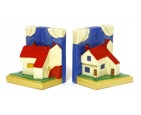 A pair of Clarice Cliff cottage bookends, printed 'Wilkinson Ltd., England, Clarice Cliff', 14cm high (2)