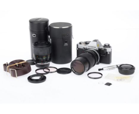 An Olympus OM-10 35mm SLR Camera Outfit, silver, serial number 2066329, body VG, shutter working, meter responds, with an Oly