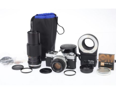 An Olympus OM-1 MD 35mm SLR Camera Outfit, silver, serial number 1018125, body VG, shutter working, meter responds, battery c