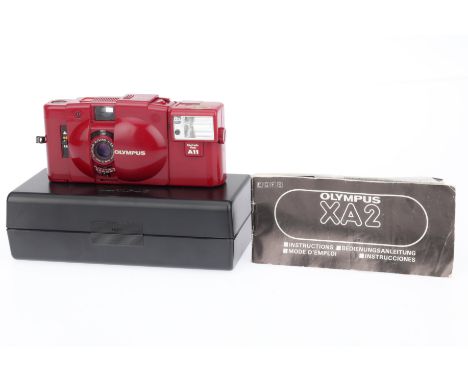 An Olympus XA2 Compact Viewfinder Camera, red, body G, shutter working, battery tested, appears to meter light, with working 