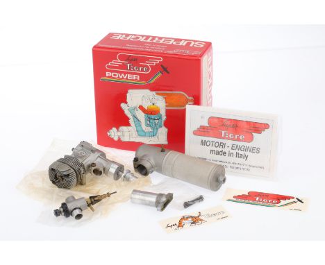A Supertigre GS40 Model Aircraft Engine, internal combustion engine, and muffler, assembled and inside maker's original packa