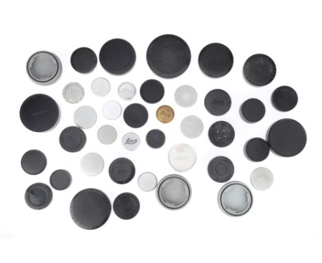 A Selection of Leitz and Leica Caps, to include body caps, lens caps, and others, mostly Leitz branded.
