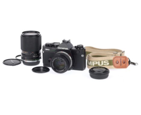 An Olympus OM-2 Spot/Program 35mm SLR Camera Outfit, black, serial number 1183276, body VG, shutter works, meter responds, wi