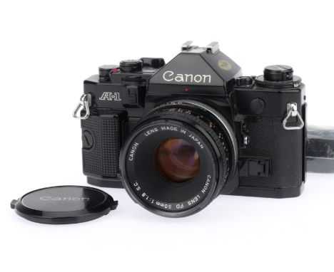 A Canon A-1 35mm SLR Camera, black, serial number 1235574, body G, shutter works well, viewfinder display working and meter r