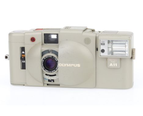 An Olympus XA2 Compact Viewfinder Camera, white, body F-G, usage marks on the back, shutter working, battery tested, appears 