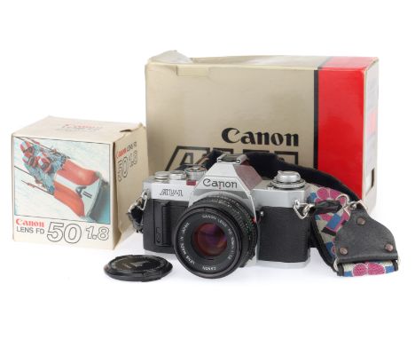 A Canon AV-1 35mm Camera, silver, serial number 532604, body G, light marks to prism housing, shutter works, viewfinder needl