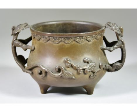 A Chinese Bronze Bombe Two-Handled Tripod Censer, 17th/18th Century, with chilong dragon handles, the rim with a band of ruyi