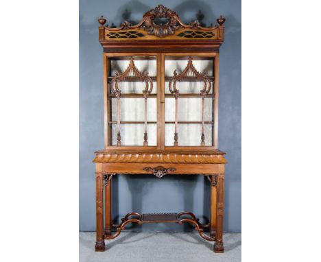 A Late 19th/Early 20th Century Mahogany Display Cabinet on Stand, of "Chinese Chippendale" Design, the upper part with cornic