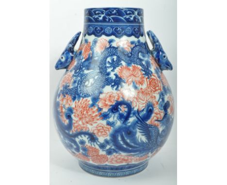 A vintage mid 20th century circa 1960s ceramic Chinese Oriental blue &amp; white twin handled vase. The vase having deer's' h