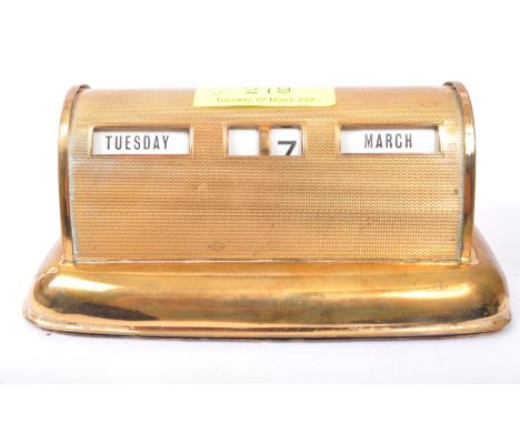 An early 20th century circa 1920's brass perpetual desk calendar. The calendar being of domed form with engine turned decorat